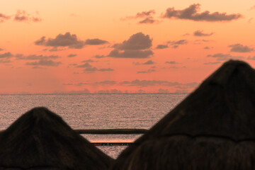 Sunrise over the cabanas on the resort beach off the Gulf of Mexico in the Riviera Maya