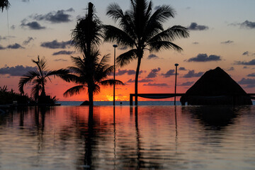 Sunrise over the Gulf of Mexico reflected into the infinity pool at the resort