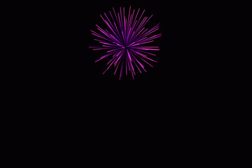 Fototapeta premium New Year's Night, Diwali, bonfire night Colourful Starbursts and Rocket Explosions on Black Background Sky with Red, Green, Blue, Purple, Gold Colour Fireworks Bursts with Space for Text-Smoke-free