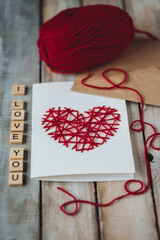 Concept of love message. I love you words written in wooden blocks. Idea for making handmade greeting cards with wooden red heart for Valentine's Day. Sweet cute bear for breakfast, envelope