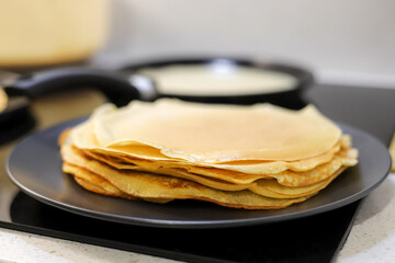 Making bliny at home. Closeup of traditional tasty thin pancakes. Photo with selective focus