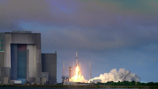 Spectacular shot of a Space Rocket blasting off from launch pad as it flies to space on its mission to place communication satellites in earth orbit. 4K. Slow-motion. Includes sound and audio.