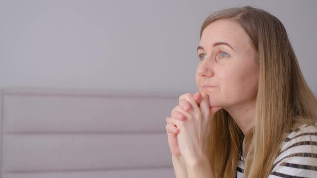 Frustrated Depressed Woman Sitting On Sofa At Home, Looking Into Distance.