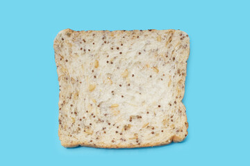 Whole grain bread slices on blue background.