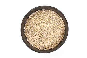 Barley groats in bowl, isolated on white background.
