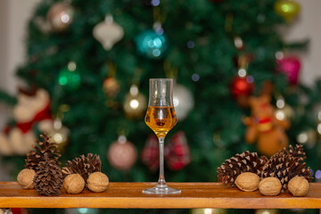 Traditional Christmas themed background and Scottish single malt whiskey in crystal tasting glass