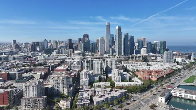 San Francisco, USA, flight along "The Embarcadero S" to Bay Bridge with Skyscraper Skyline of "South of Market" (SoMA) district and famous Salesforce Tower- aerial video footage 