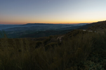 View from Serra da Arada over mountain landscape at evening twilight with crescent moon, Sao Pedro...