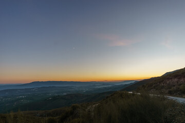 Fototapeta na wymiar View from Serra da Arada over mountain landscape at evening twilight with crescent moon, Sao Pedro do Sul, Portugal