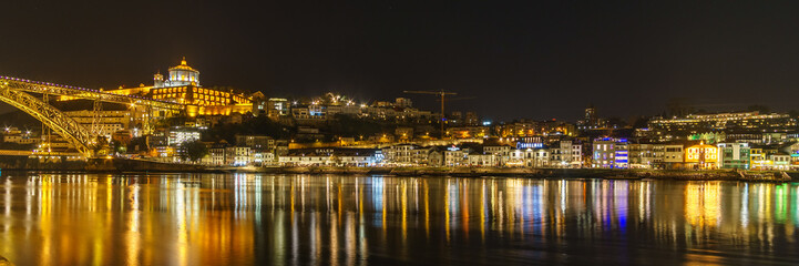 Panoramic night view over Vila Nova de Gaia seen from Ribeira do Porto with Dom Luis Bridge and...