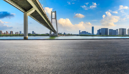 asphalt road ground and city skyline with bridge building in suzhou china