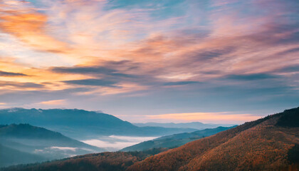 autumn sunrise cloudy sky over mountains abstract colorful peaceful sky background