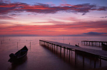 Fototapeta na wymiar boat at sunrise on the lake