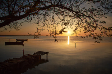 pontoon at sunrise on the lake