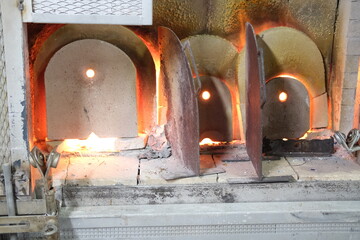 A close-up of a glass foundry furnace at  Murano. Venice, Italy - November 12, 2023.