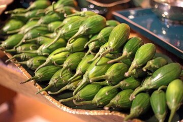 plate arrangement of small green eggplants for table decoration