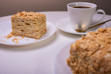 close up view, napoleon cake on light surface, white plate, side view. Place for inscription