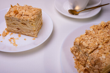 close up view, napoleon cake on light surface, white plate, side view. Place for inscription