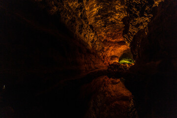 cueva de los verdes, colorful vulcanic rocks in cave with lake still calm reflecting, lava tube in Lanzarote, Canary Islands