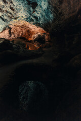 cueva de los verdes, colorful vulcanic rocks in cave with lake still calm reflecting, lava tube in Lanzarote, Canary Islands