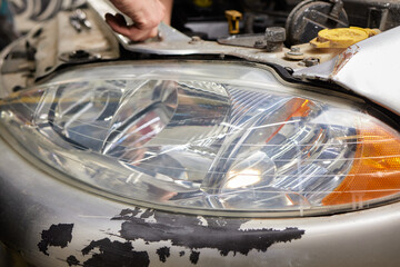Big headlight cleaning on the car with power buffer machine at service station ,Before and after...