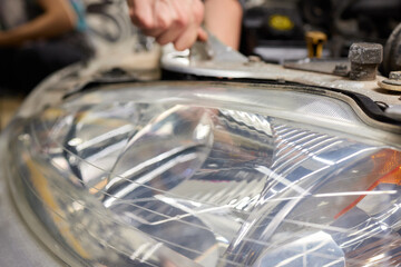 Big headlight cleaning on the car with power buffer machine at service station ,Before and after...