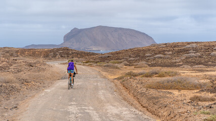 biker cycling in la graciosa island, Lanzarote, sustainable travel vacation healty lifestyle