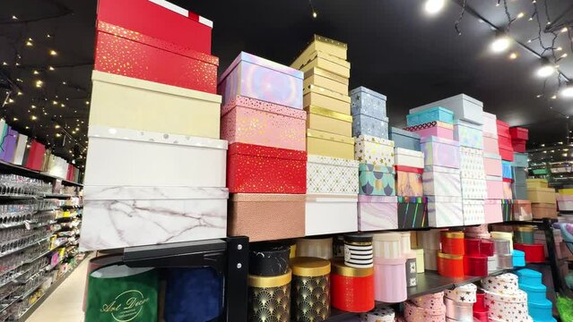 A large selection of gift boxes in different shapes and colors for giving to loved ones for holidays and important holidays and events. Christmas gift boxes on the shelves of a gift shop. 