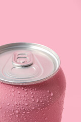 Can of fresh soda with water drops on pink background, closeup