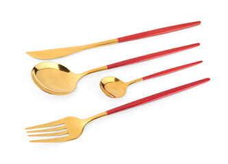 Golden set of cutlery with red handles on white background