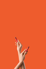 Woman with lipsticks on red background