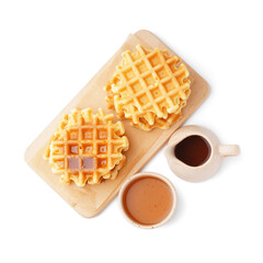 Wooden board of tasty waffles with maple syrup on white background