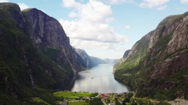 Drone flies in the valley of beautiful Lysefjord Norway with scenic mountains and cliff walls high above the fjord - 4K