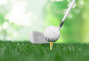 White golf ball on classic sport tee at course.