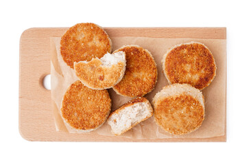 Wooden board of tasty meat cutlets on white background