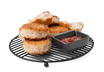 Grid of tasty meat cutlets with sauce on white background