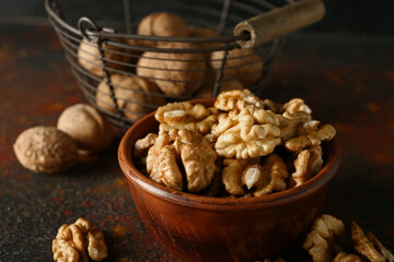 Bowl of tasty walnuts on table