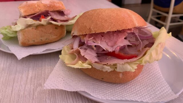 Video of traditional peruvian sandwich called "Butifarra" or "sandwich de lechon". Food concept.