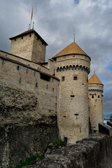Fototapeta na wymiar The turrets of Chillon Castle Montreux Switzerland against storm clouds