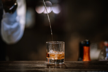 Bartender Serve Whiskey, on wood bar.