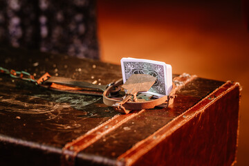 Playing card and animal trap, game trap, on a wooden background, get into gambling addiction.