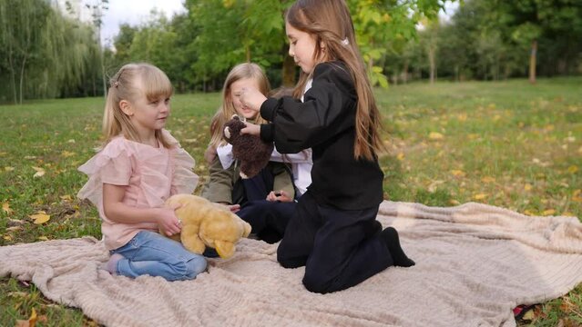 Group of happy children playing in the park together on the grass 4k