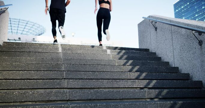Running, fitness and couple of friends in city for cardio training, exercise and race challenge on stairs. Back of personal trainer, man and woman runner on steps for outdoor workout for body health