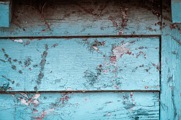 Distressed barn siding with bright teal pain