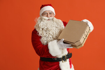 Santa Claus with pizza boxes on orange background