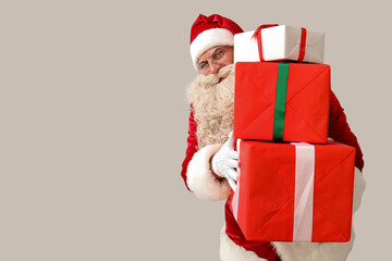 Santa Claus with Christmas gifts on white background