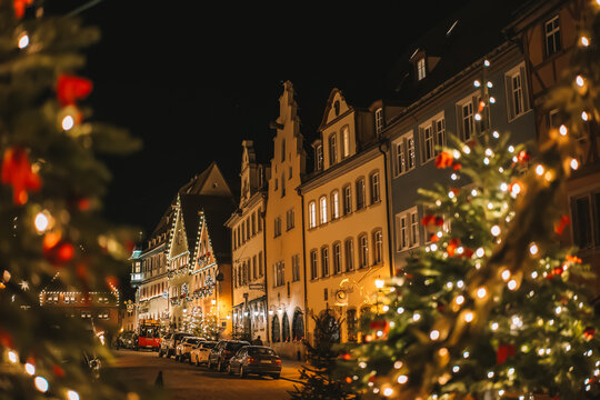 Rothenburg ob der Tauber.Christmas town background.Christmas in Europe. Christmas tree with balls and shining garlands. Christmas evening square with people walking. Soft focus. 