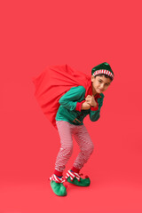 Cute little elf with bag of gifts on red background