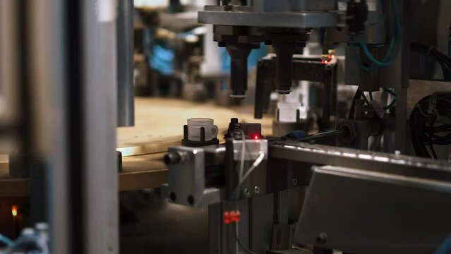 Close-up automatic industrial equipment producing plastic stub. Machines sorting components for plumbers. Industrial line. Robotics and automation. Plastic stub products processing factory. 50 fps
