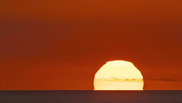 Time lapse of the sun setting over the ocean in Hawaii.